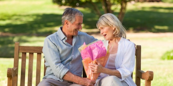 A senior couple enjoying a conversation in a sunny park